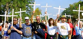 Group of protesters holding up crosses.