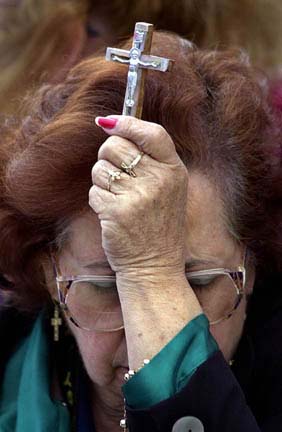 Woman prays for Elian.