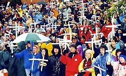 Crowd of protesters holding crosses.