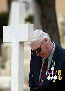 Brian Grundy prays at family gravesite - photo by Darrin Zammit Lupi.