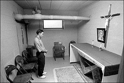 Priest Justin Ky praying - photo by Christopher Record.