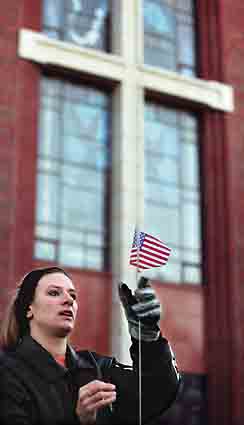 Christi Osentowski puts American flag on car - photo by Barrett Stinson.
