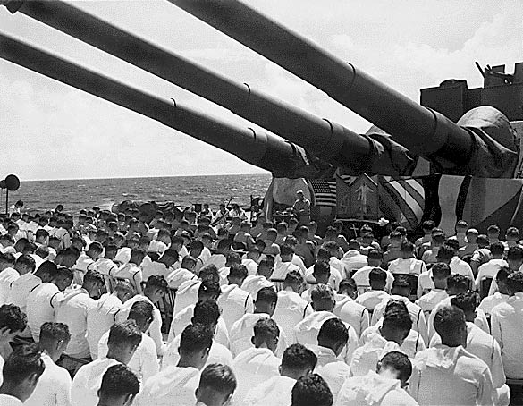 Crew with bowed heads on the USS SOUTH DAKOTA.